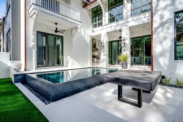 view of pool with ceiling fan and a patio area