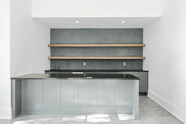 bar with sink and gray cabinetry