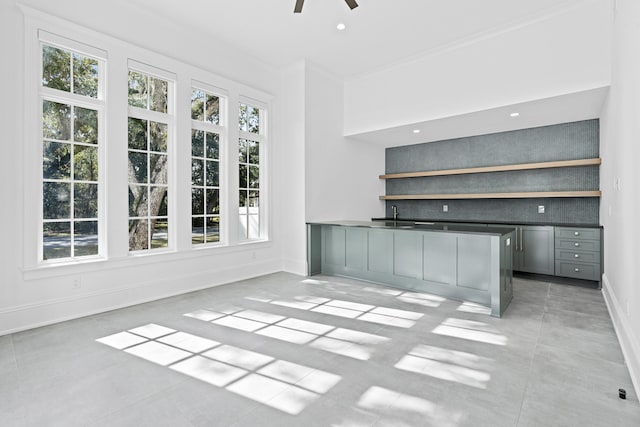 unfurnished office featuring ceiling fan and ornamental molding