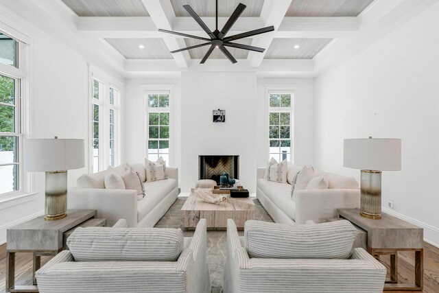 living room featuring beam ceiling, hardwood / wood-style floors, and coffered ceiling