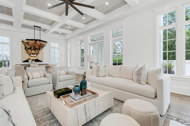 living room with ceiling fan, coffered ceiling, light hardwood / wood-style floors, and beam ceiling