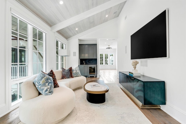 living area with beamed ceiling, hardwood / wood-style floors, wood ceiling, and high vaulted ceiling