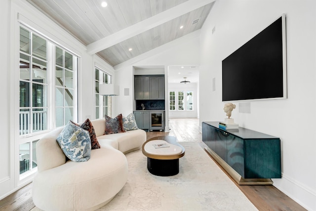 living room featuring wine cooler, vaulted ceiling with beams, wood-type flooring, and wooden ceiling