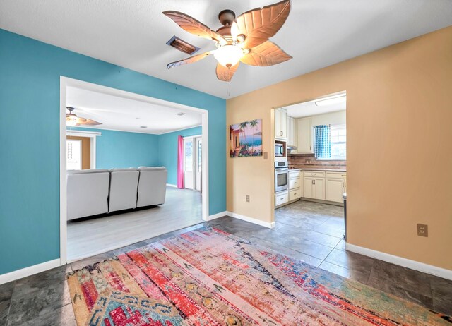 interior space featuring ceiling fan and tile floors