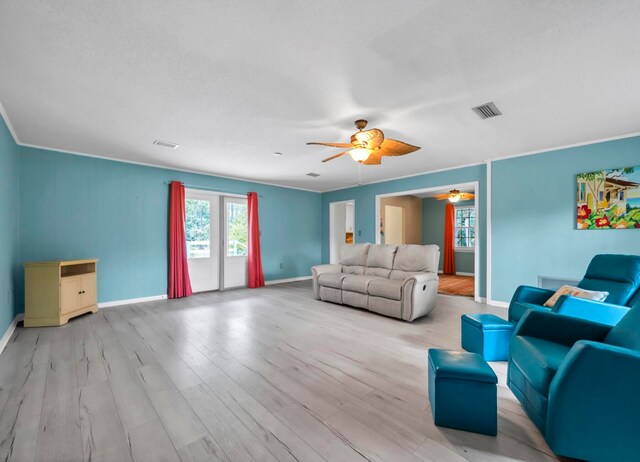 living room with ceiling fan and light wood-type flooring