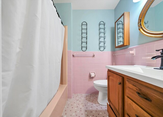 full bathroom featuring tile walls, backsplash, toilet, tile floors, and vanity