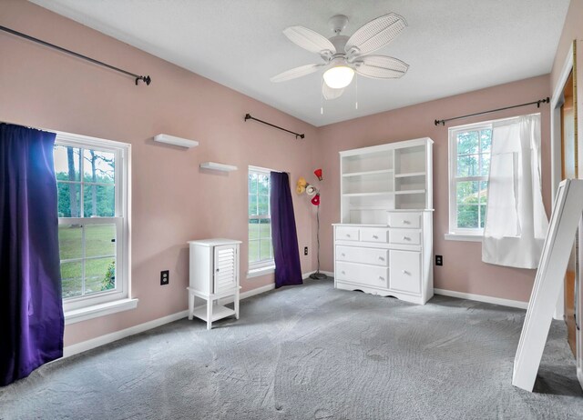 unfurnished bedroom with light colored carpet and ceiling fan