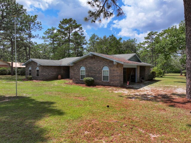 ranch-style home with a front yard