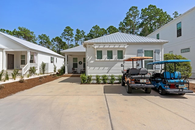 view of front of property with covered porch and metal roof