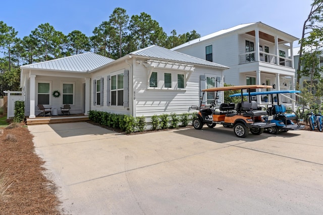 view of front of house with covered porch and metal roof