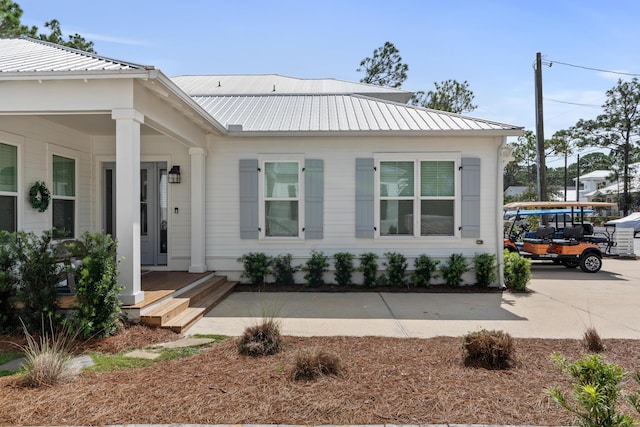 view of home's exterior with driveway and metal roof