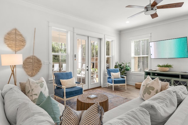 living room with baseboards, ceiling fan, ornamental molding, french doors, and wood finished floors