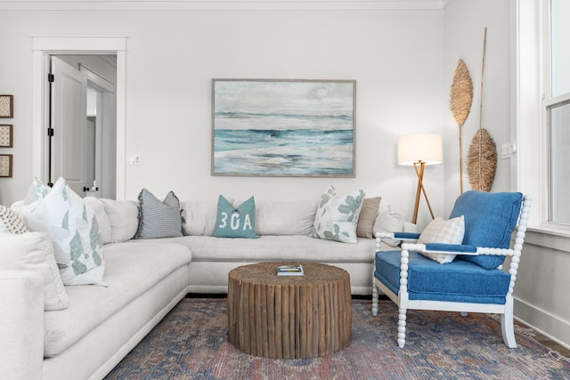 living area featuring baseboards and carpet flooring