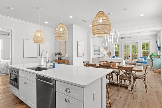 kitchen with visible vents, ceiling fan, a sink, appliances with stainless steel finishes, and open floor plan