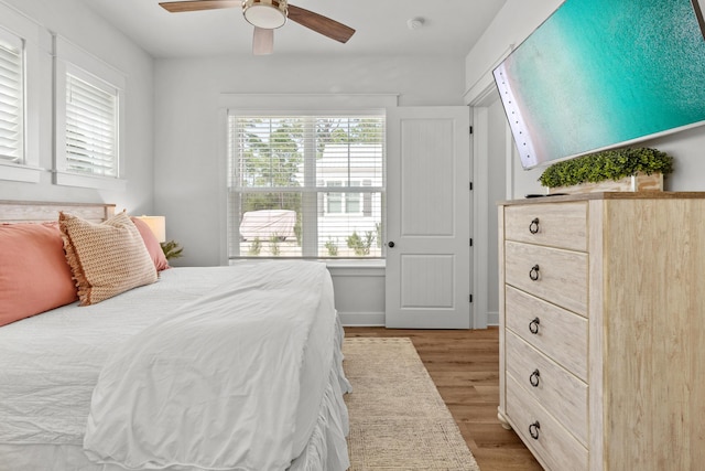 bedroom with a ceiling fan and wood finished floors