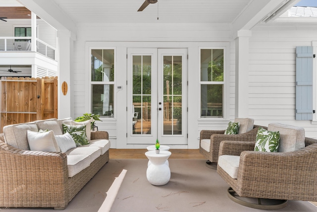 sunroom / solarium featuring a ceiling fan, french doors, and a healthy amount of sunlight