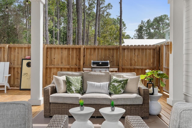 view of patio featuring a deck, area for grilling, fence, and an outdoor hangout area