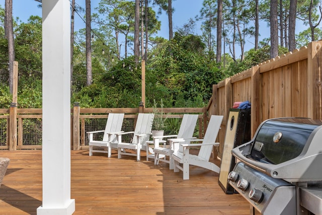 wooden terrace featuring a grill