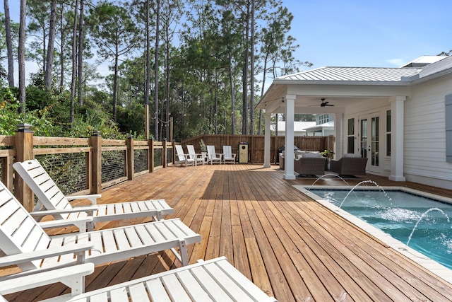 deck featuring fence, french doors, a fenced in pool, an outdoor hangout area, and ceiling fan