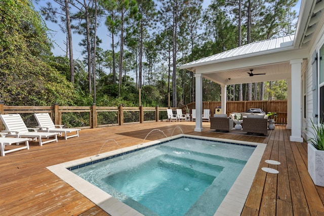 view of swimming pool with a wooden deck, an outdoor hot tub, outdoor lounge area, and fence