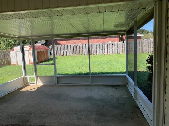 unfurnished sunroom with wooden ceiling