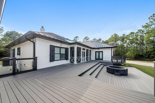 wooden deck with an outdoor fire pit