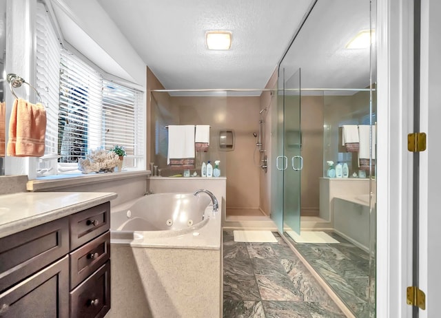 bathroom with tile flooring, vanity, a textured ceiling, and plus walk in shower