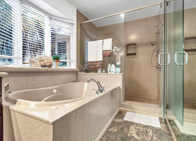 bathroom featuring a textured ceiling, tile floors, and plus walk in shower