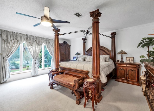 carpeted bedroom featuring ceiling fan and a textured ceiling