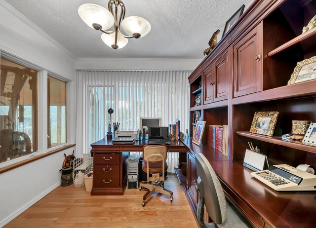 home office featuring a chandelier, ornamental molding, light hardwood / wood-style flooring, and a textured ceiling