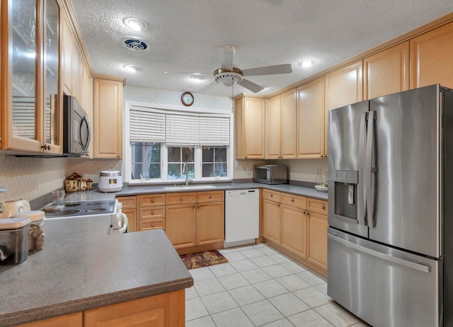 kitchen with appliances with stainless steel finishes, a textured ceiling, ceiling fan, and light tile floors