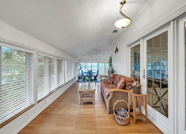 sunroom / solarium featuring lofted ceiling and french doors