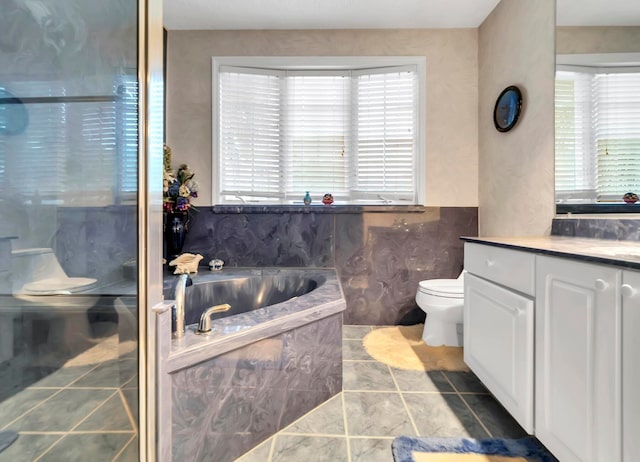 bathroom with plenty of natural light, a bath to relax in, toilet, and tile floors