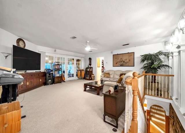 carpeted living room featuring ceiling fan and french doors