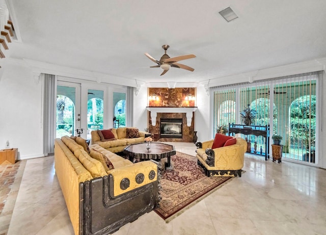 tiled living room featuring a wealth of natural light, ceiling fan, and french doors