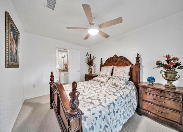 carpeted bedroom featuring ensuite bath and ceiling fan