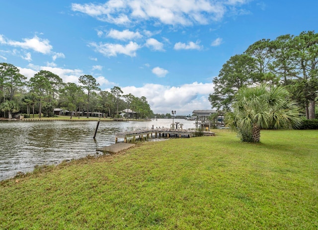 dock area with a water view and a lawn