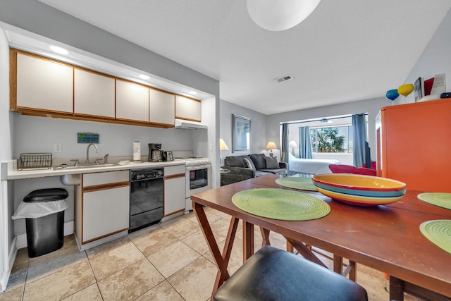 kitchen featuring dishwasher, white gas stove, white cabinets, sink, and light tile floors