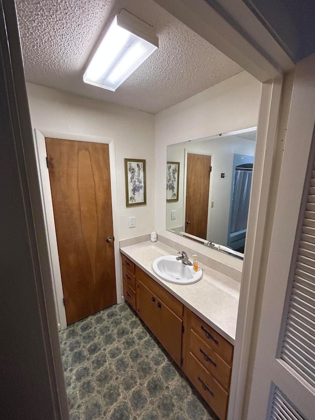 bathroom featuring vanity and a textured ceiling