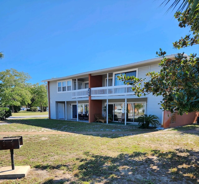 rear view of house with a yard