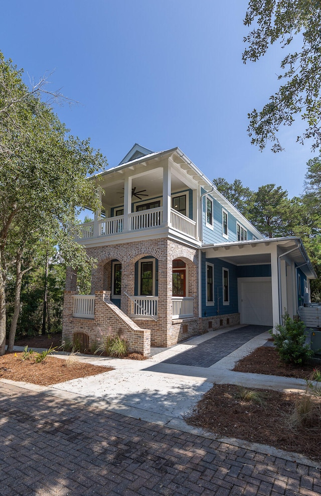 view of front of house featuring a balcony, covered porch, and a carport