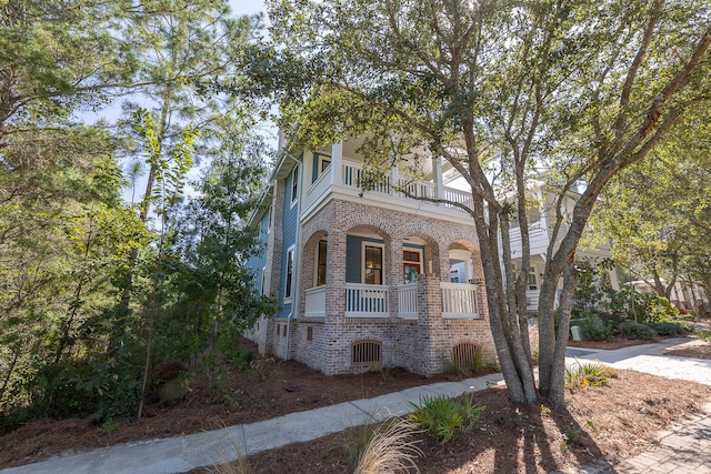 view of front of property featuring a porch and a balcony