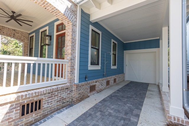 exterior space with a garage, ceiling fan, and a porch