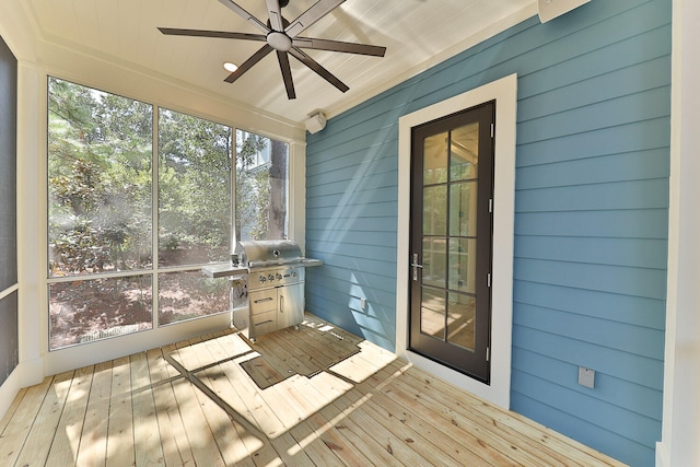 unfurnished sunroom featuring ceiling fan