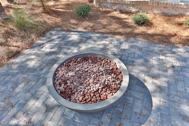 exterior details featuring an outdoor fire pit