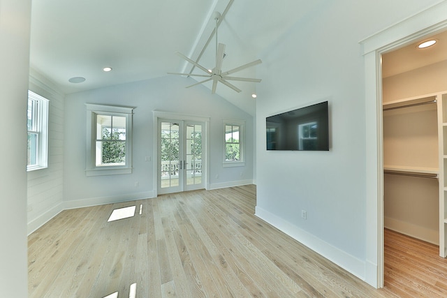 interior space featuring vaulted ceiling, french doors, ceiling fan, and light hardwood / wood-style floors