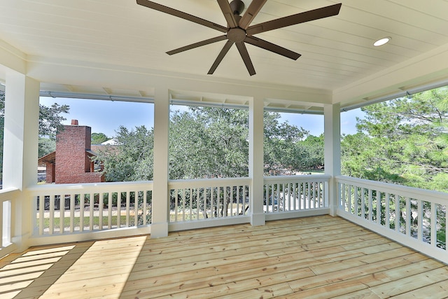 unfurnished sunroom featuring ceiling fan