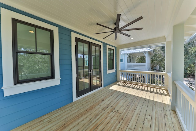 wooden deck featuring ceiling fan