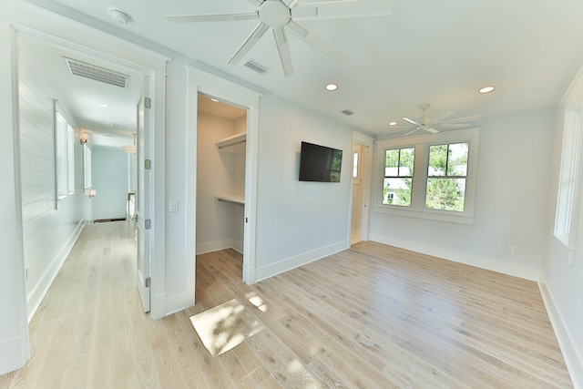 unfurnished room with ceiling fan and light wood-type flooring