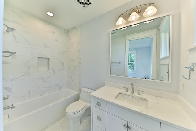 full bathroom with tile flooring, oversized vanity, tiled shower / bath, and toilet